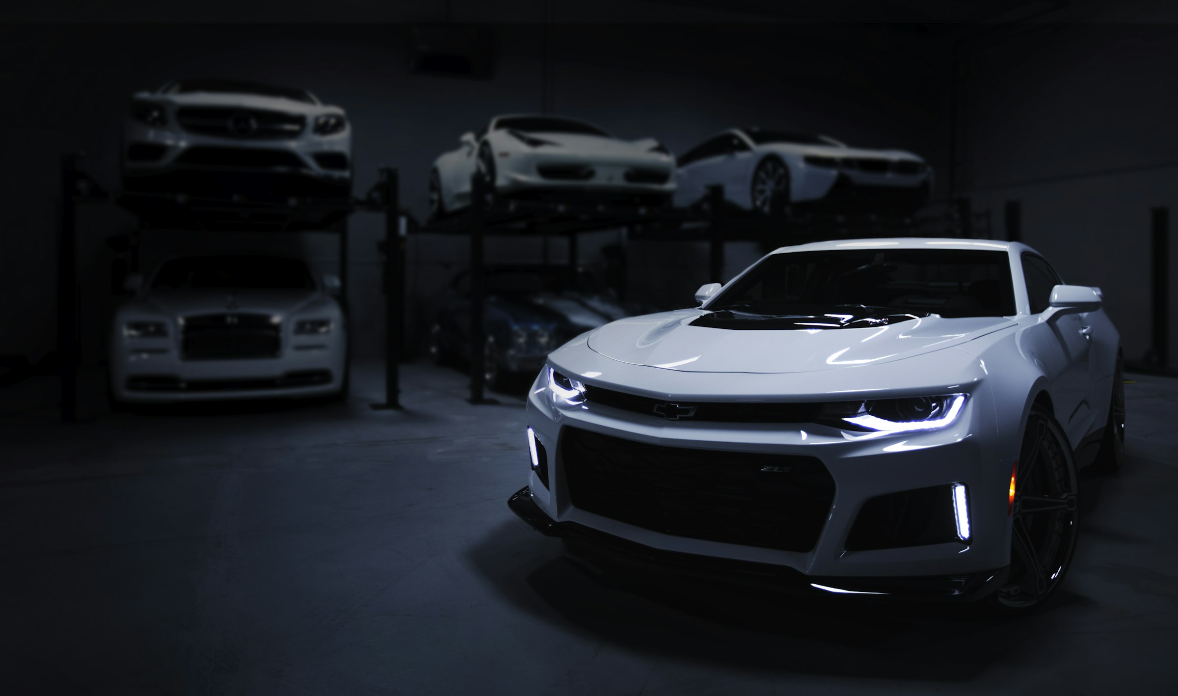 White sports car in a dark garage