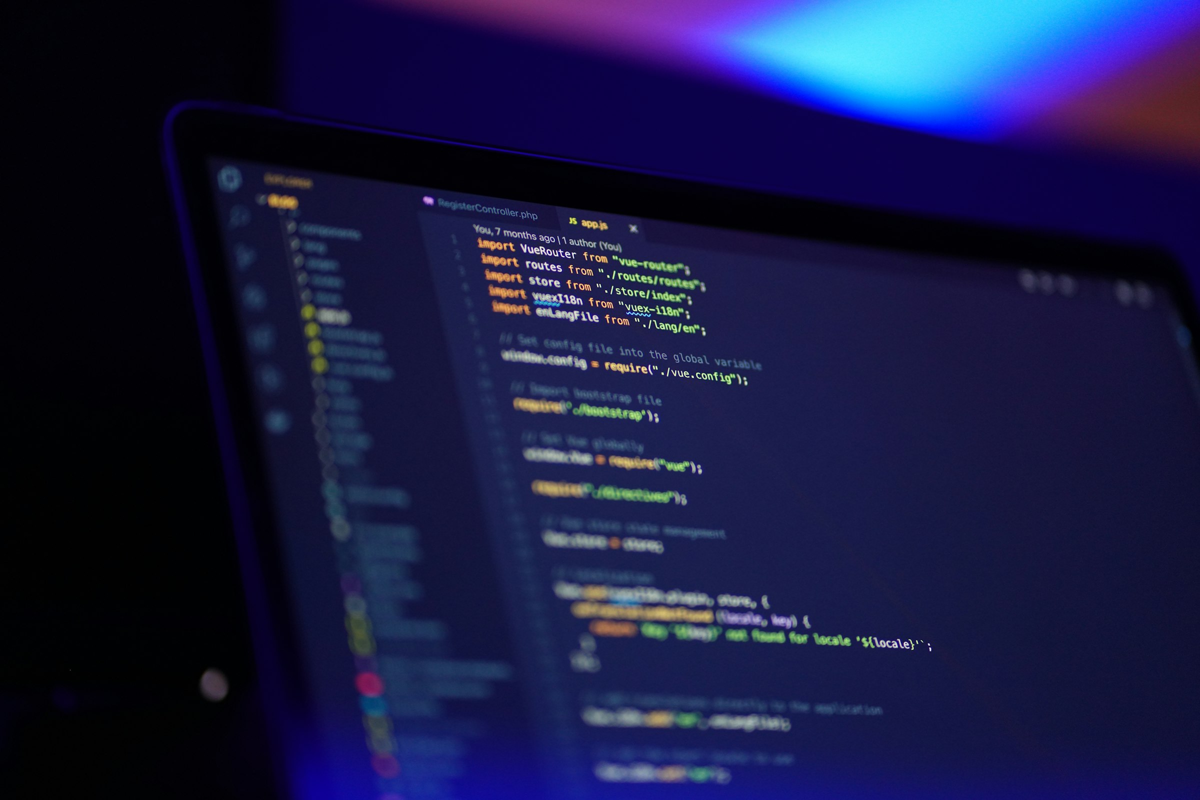 Laptop screen showing colourful source code